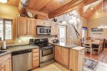 Arrow Lodge -Kitchen with wood cabinets and trim.
